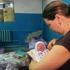 A woman holds her newborn baby as they take shelter in the basement of a perinatal centre in Kharkiv