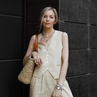 Žena v elegantním kompletu: vesta a široké kalhoty