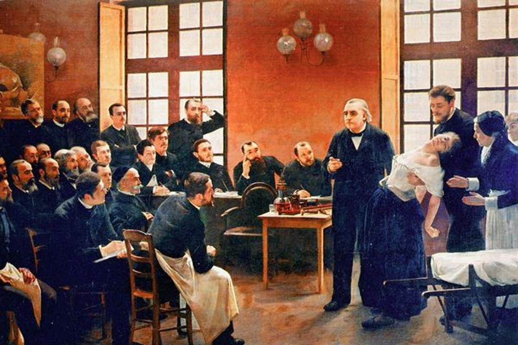 Charcot v auditoriu předvádí na Blanche Wittmanové záchvat hysterie. (Autor: André Brouillet, 1887)
A Clinical Lesson at the Salpêtrière (1887, detail).