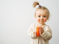 A,Baby,With,A,Food,Allergy,Holds,A,Carrot,In