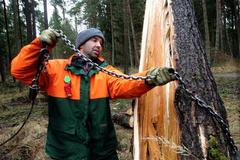 Dělník s řetězem v lese