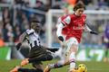 Newcastle United's Tiote challenges Arsenal's Rosicky during their English Premier League soccer match in Newcastle