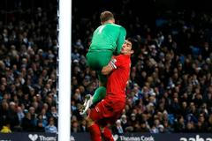 Liverpool's Suarez collides with Manchester City's Hart during their English Premier League soccer match in Manchester