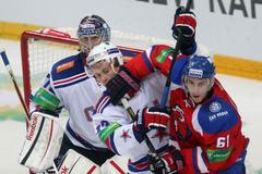 Hokejista Lva Praha Erik Christensen v souboji s Ivanem Něprjajevem před Sergejem Bobrovským v utkání KHL proti SKA Petrohradu.