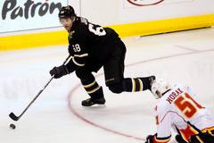 Jaromír Jágr vede puk před Romanem Horákem z Calgary