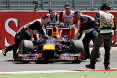 Marshalls remove abandoned car of Red Bull Formula One drive