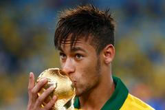Brazil's Neymar kisses the trophy after winning their Confed