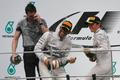 Mercedes Formula One driver Hamilton of Britain celebrates with team mate second-placed Rosberg of Germany and team engineer Shovlin after winning the Malaysian F1 Grand Prix at Sepang International C