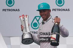 Mercedes Formula One driver Hamilton of Britain celebrates on the podium after winning the Malaysian F1 Grand Prix at Sepang International Circuit outside Kuala Lumpur