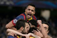 Barcelona players celebrate Lionel Messi's penalty against Manchester City during their Champions League round of 16 first leg soccer match at the Etihad Stadium in Manchester