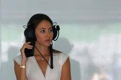 Jessica Michibata listens to the radio during the first practice session of the Malaysian F1 Grand Prix at Sepang International Circuit outside Kuala Lumpur