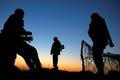 Ukrainian soldiers man a military check point by a camp on a field the Ukrainian Army forces set up close to the Russian border in east Ukraine