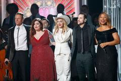 Macklemore, Lambert, Madonna, Lewis and Queen Latifah stand together after performing "Same Love" at the 56th annual Grammy Awards in Los Angeles