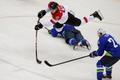 Austria's Michael Raffl flies through the air after tripping over Slovenia's Ziga Pavlin during the second period of their men's ice hockey playoffs qualification game at the 2014 Sochi Winter Olympic