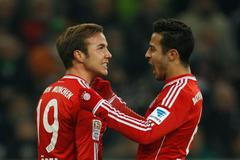 Bayern Munich's Goetze and Thiago celebrate a goal against Borussia Moenchengladbach during the German first division Bundesliga soccer match in Moenchengladbach