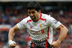 Liverpool's Suarez celebrates after scoring his side's third goal during their English Premier League soccer match against Manchester United at Old Trafford in Manchester