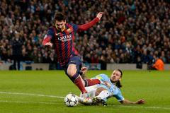 Manchester City's Martin Demichelis fouls Barcelona's Lionel Messi to concede a penalty during their Champions League round of 16 first leg soccer match at the Etihad Stadium in Manchester