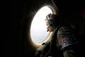 RAAF Warrant Officer Mikeska looks out of a RAAF C-130J Hercules aircraft as it flies over the southern Indian Ocean in search for the missing Malaysian Airlines MH370