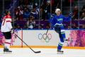 Slovenia's Kovacevic celebrates his goal as Austria's Lebler reacts during second period of their men's ice hockey playoffs qualification game at 2014 Sochi Winter Olympics