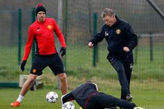 Manchester United's manager Moyes is challenged by Rooney during a training session at the club's Carrington training complex in Manchester
