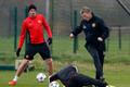Manchester United's manager Moyes is challenged by Rooney during a training session at the club's Carrington training complex in Manchester