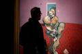 A visitor looks at "Portrait of George Dyer Talking" by Francis Bacon in 1966 on display at Christie's in London