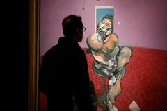 A visitor looks at "Portrait of George Dyer Talking" by Francis Bacon in 1966 on display at Christie's in London