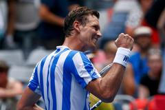 Tomas Berdych of Czech Republic celebrates defeatind Damir Dzumhur of Bosnia and Herzegovina in their men's singles match at the Australian Open 2014 tennis tournament in Melbourne