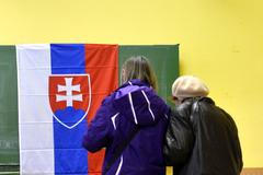 People cast their ballots at a polling station during the first round presidential elections in Bratislava