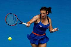 Vesna Dolonc of Serbia hits a return to Serena Williams of the U.S. during their women's singles match at the Australian Open 2014 tennis tournament in Melbourne