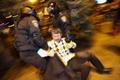 Police officers drag a wounded participant of an anti-war rally during clashes with pro-Russian demonstrators in Donetsk