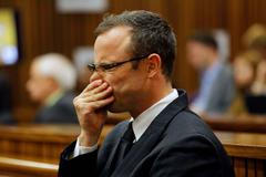 Olympic and Paralympic track star Oscar Pistorius sits in the dock at the North Gauteng High Court in Pretoria