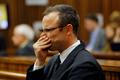 Olympic and Paralympic track star Oscar Pistorius sits in the dock at the North Gauteng High Court in Pretoria