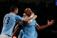 Manchester City's Kompany celebrates with teammates after scoring a goal against Liverpool during their English Premier League soccer match in Manchester