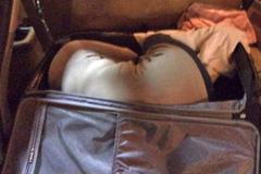 Handout U.S. Customs and Border Protection photo shows a woman in a suitcase