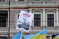 Ukraine's flags and a poster are pictured in front of Russia's embassy during a protest rally against Russian intervention in Crimea, in Riga
