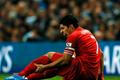 Liverpool's Suarez holds his leg during their English Premier League soccer match against Manchester City in Manchester