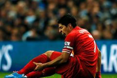 Liverpool's Suarez holds his leg during their English Premier League soccer match against Manchester City in Manchester