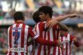 Atletico Madrid's Koke is congratulated by his teammates Costa and Adrian after scoring a goal against Malaga during their Spanish First Division soccer match in Malaga