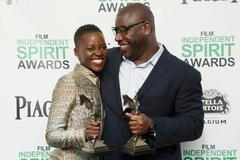 Actress Nyong'o and director McQueen pose with their awards for "12 Years a Slave" backstage at the 2014 Film Independent Spirit Awards in Santa Monica