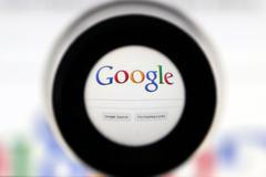 A Google search page is seen through a magnifying glass in this photo illustration taken in Brussels