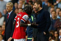 Arsenal's Sagna reacts after he was hit by a ball thrown by Tottenham Hotspur's manager Sherwood during their English Premier League soccer match in London