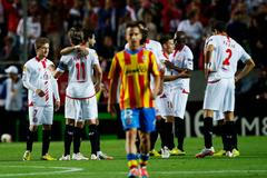 Sevilla's players celebrate winning after the end of their soccer match against Valencia in Seville