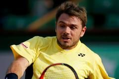 Stan Wawrinka of Switzerland returns a backhand to Guillermo Garcia-Lopez of Spain during their men's singles match at the French Open tennis tournament at the Roland Garros stadium in Paris