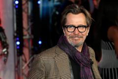 File photo of cast member Oldman posing for photographers as he arrives at the premiere of Robocop at the BFI IMAX Southbank in London