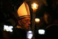 Pope Francis holds a candle as he leads a vigil mass during Easter celebrations at St. Peter's Basilica in the Vatican