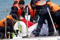 South Korean coastguard officers recover a body on their vessel at the site where the capsized passenger ship Sewol sank in the sea off Jindo