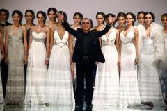 File photo shows Italian designer Roberto Cavalli acknowledging the crowd after models presented his collection during the Cali Exposhow in Cali