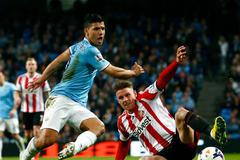 Manchester City's Aguero challenges Sunderland's Wickham during their English Premier League soccer match at the Etihad stadium in Manchester