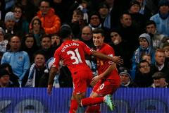 Liverpool's Coutinho celebrates with teammate Sterling after scoring a goal against Manchester City during their English Premier League soccer match in Manchester